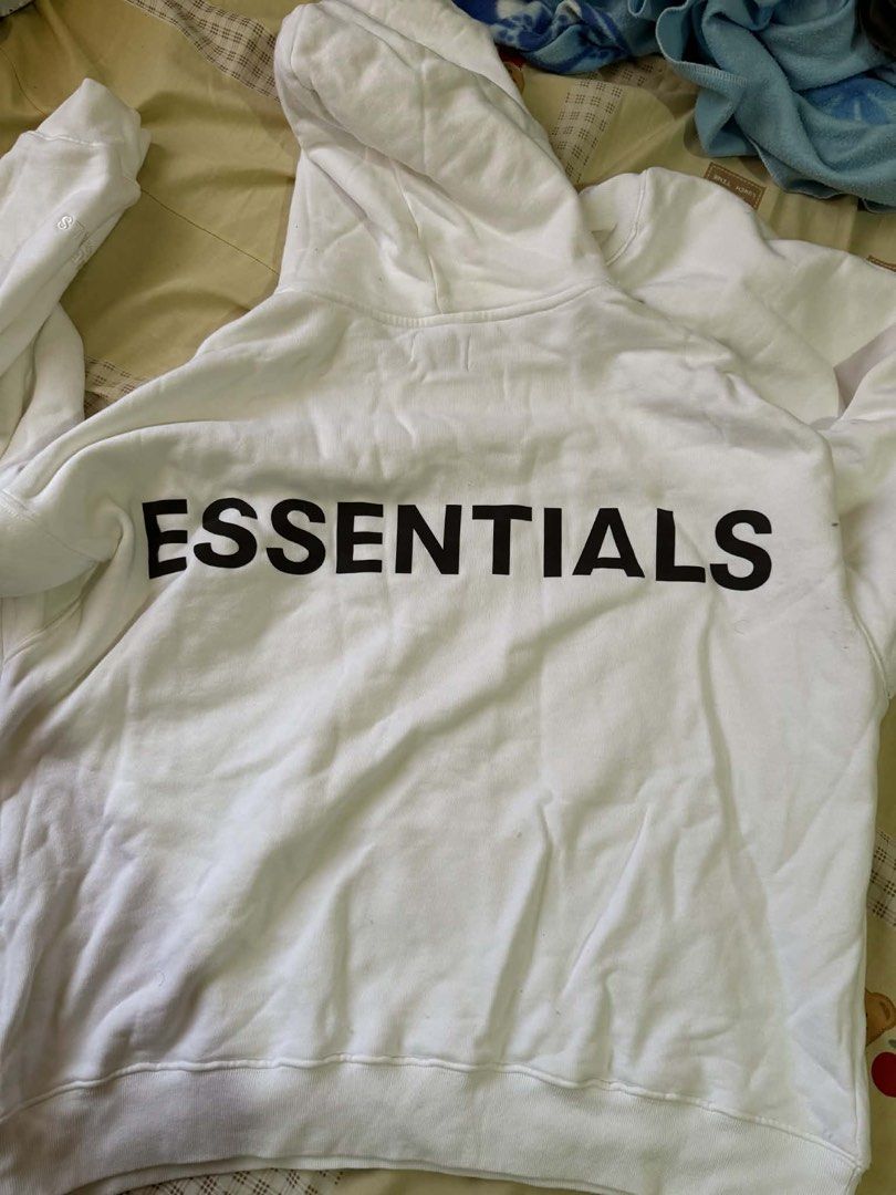 Essentials Fear of God Hoodie (Category: Hoodies) located in Manila. Submitted by scarlett.love (Listing ID 1436674861, Image 3). Description: - White Essentials Fear of God hoodie - Features a hood with the Essentials tag - Black Essentials logo printed on the back - Kangaroo pocket in the front - Relaxed fit - ORIGINAL.