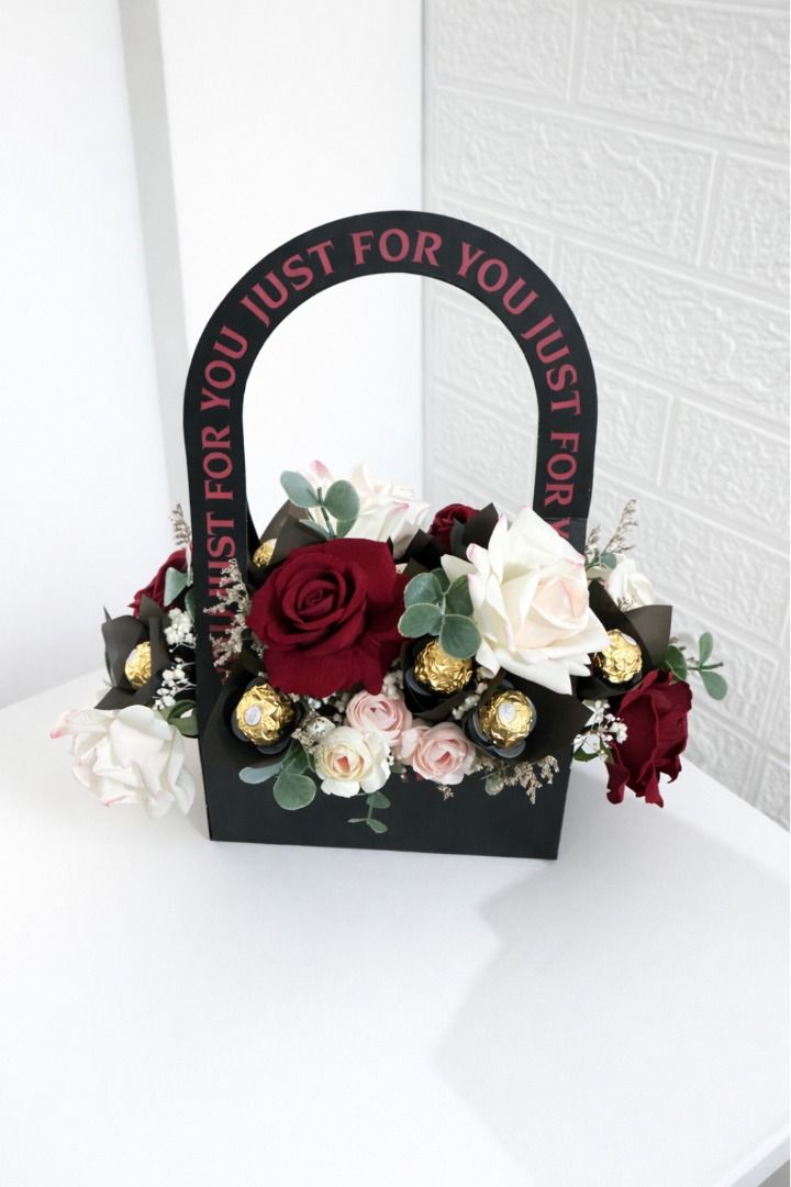 Floral Gift Basket with Ferrero Rocher (Category: Flowers & Bouquets) located in Valenzuela. Submitted by acelpz (Listing ID 1436804888, Image 2). Description: - Elegant floral arrangement - Black gift basket with handle - Features: Red and white roses, small pink flowers, greenery - Can include 8 to 16 pcs Ferrero Rocher chocolates - Free paper bag with note card - Same day delivery available For more info, visit our FB page @Floresca by CA.