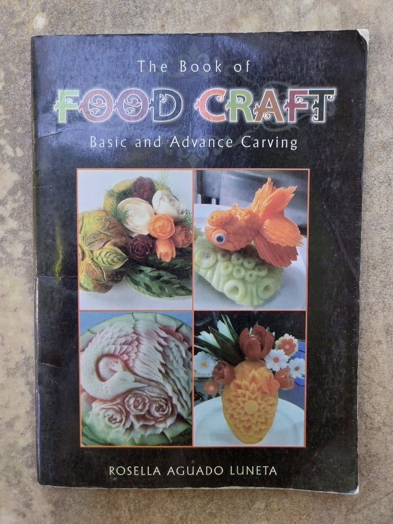 Food Craft Carving Tools Set with Book (Category: Craft Supplies & Tools) located in Lipa City. Submitted by billy_lojo888 (Listing ID 1436785820, Image 2). Description: - Food carving tool set - Includes a variety of tools - Comes with "The Book of Food Craft" by Rosella Aguado Luneta - Tools stored in a denim-like case - Features examples of food art - Suitable for beginners and advanced carvers.