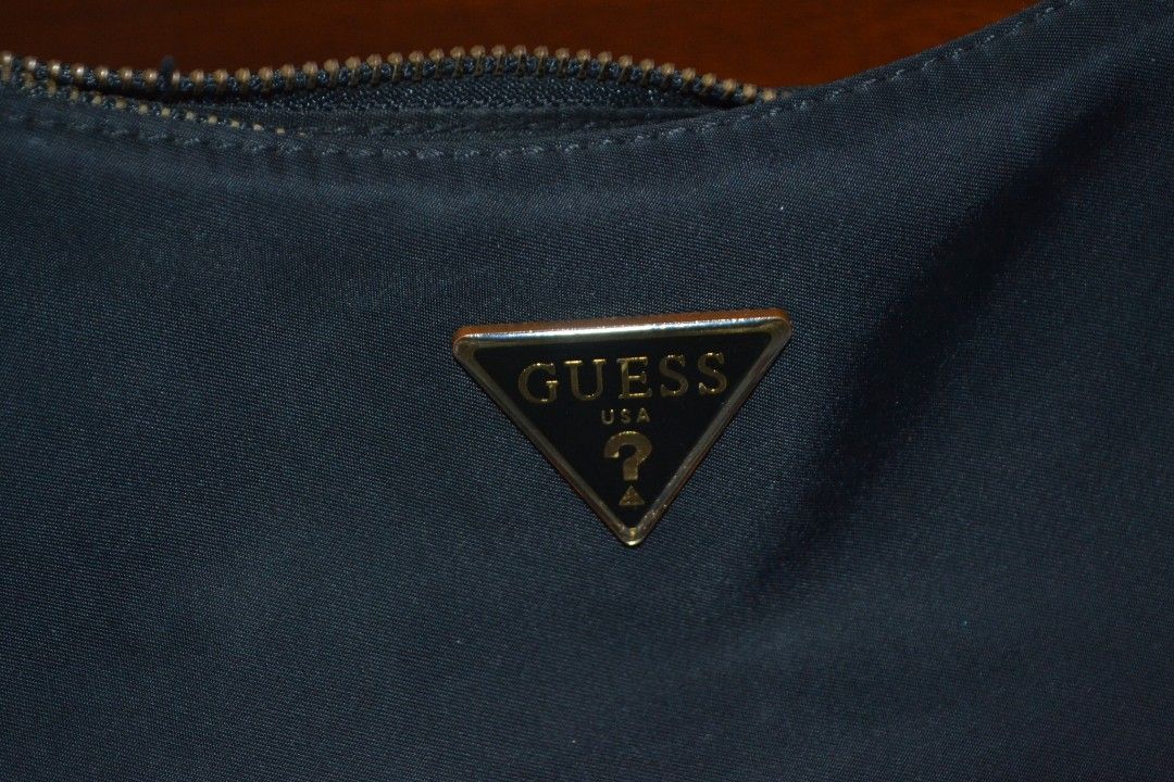 Guess Black Shoulder Bag (Category: Shoulder Bags) located in Valenzuela. Submitted by miss_merix (Listing ID 1436731011, Image 2). Description: - Black Guess shoulder bag - Gold-tone Guess logo - Zipper closure - Curved shape - Shoulder strap - Made of nylon.