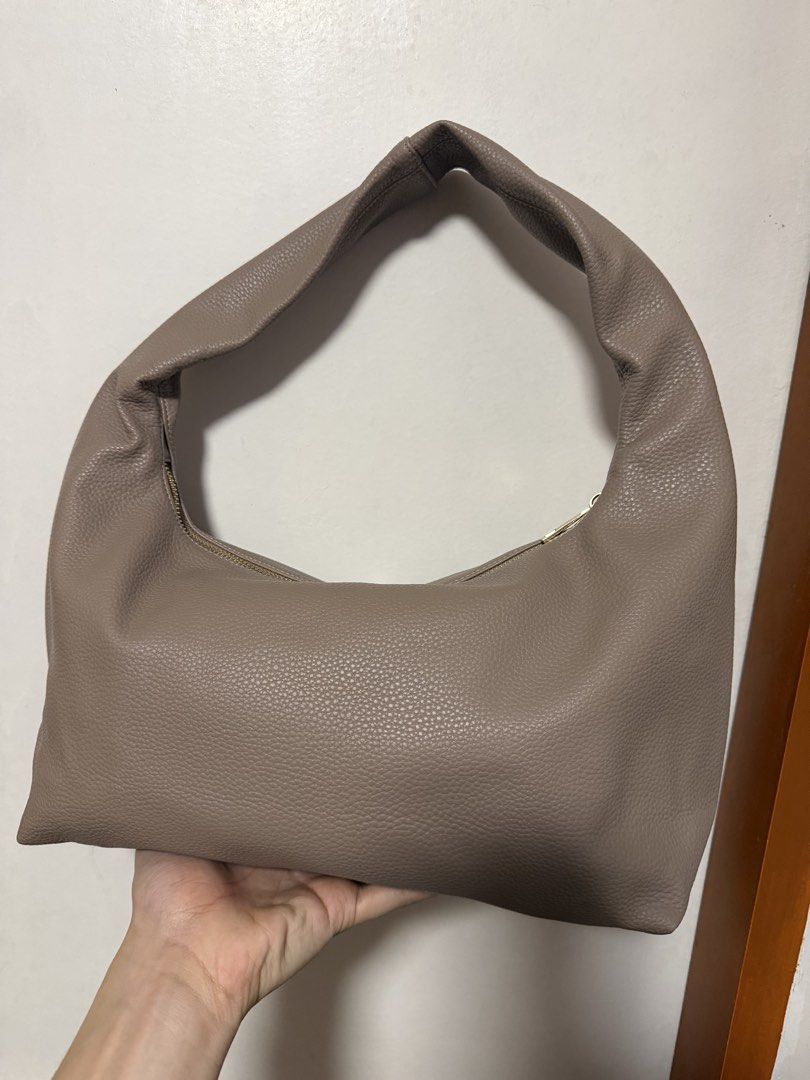 GVN Taupe Hobo Bag (Category: Shoulder Bags) located in Manila. Submitted by paaaaaeng (Listing ID 1436817195, Image 2). Description: - Taupe Hobo Bag - Wide, single strap - Gold-colored zipper - Pebbled texture - Minimalist design - Spacious interior - Versatile neutral color - Perfect for everyday use - Willing to negotiate .