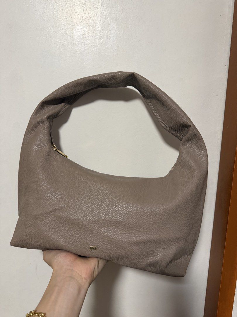 GVN Taupe Hobo Bag (Category: Shoulder Bags) located in Manila. Submitted by paaaaaeng (Listing ID 1436817195, Image 1). Description: - Taupe Hobo Bag - Wide, single strap - Gold-colored zipper - Pebbled texture - Minimalist design - Spacious interior - Versatile neutral color - Perfect for everyday use - Willing to negotiate .