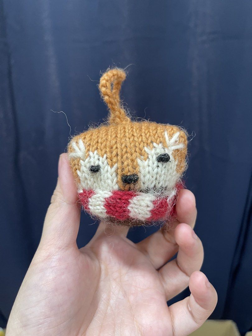 Handmade Knitted Fox Ornament (Category: Handmade Craft) located in Taguig. Submitted by supplementary (Listing ID 1436682924, Image 1). Description: - Handmade knitted fox ornament - Features a brown body and white face - Includes a red and white striped scarf - Has black eyes - Comes with a small loop for hanging - Perfect for home decor or as a unique gift.