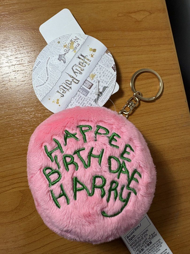 Harry Potter Happy Birthday Keychain (Category: Charms) located in San Fernando. Submitted by sammypgirl (Listing ID 1436804957, Image 2). Description: - Pink, fluffy keychain - Features "Happy Birthday Harry" embroidery - Green embroidery color - Gold-colored keyring - Official Harry Potter merchandise - Includes attached tag.
