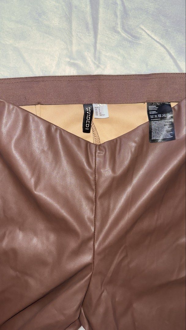 H&M Brown Faux Leather Pants (Category: Other Bottoms) located in Cebu City. Submitted by howhowthecarabao (Listing ID 1436718649, Image 3). Description: - Rich brown color - High-waisted design - Measurements: Length: 102 cm Rise: 24 cm Inseam: 73 cm - Slight flare at the bottom - Split hem detail - Fitted silhoutte - Not used .