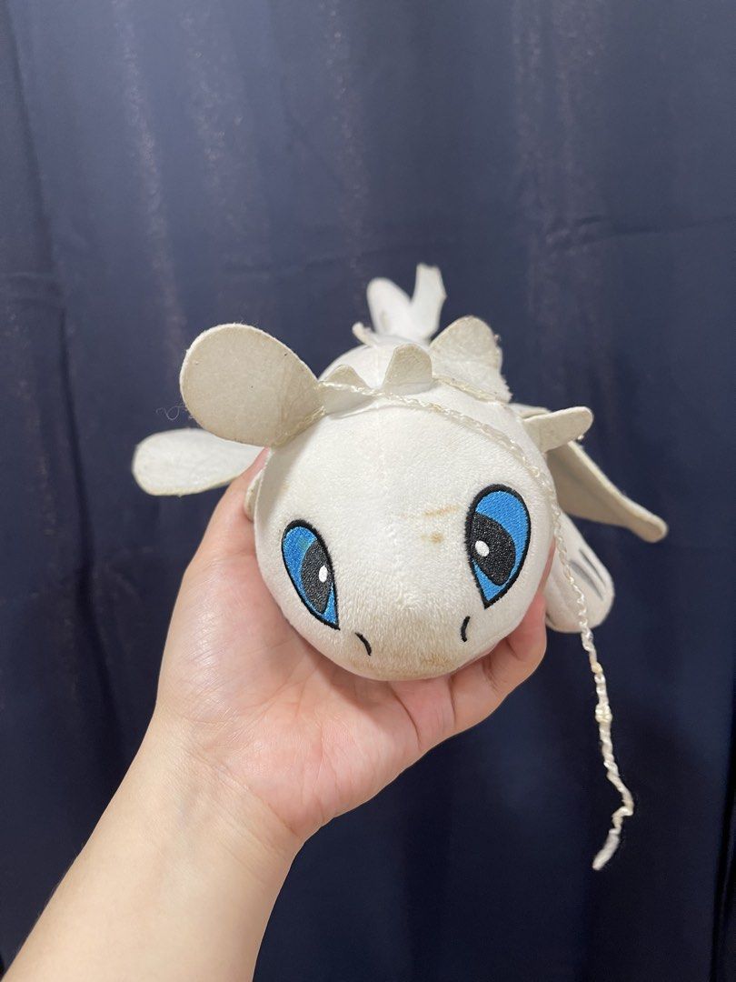 How to Train Your Dragon Light Fury Plush (Category: Plushies & Soft Toys) located in Taguig. Submitted by supplementary (Listing ID 1436670857, Image 1). Description: Light Fury plush toy features a white body with blue eyes and detailed wings. It has a soft, plush texture and is designed to resemble the character from the "How to Train Your Dragon" series..
