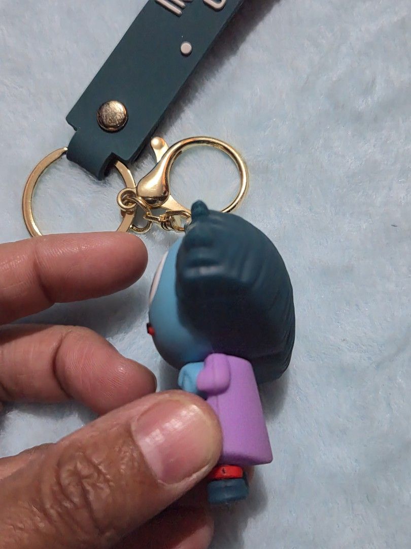 Inside Out Sadness Key Chain (Category: Character Goods) located in Mandaue City. Submitted by chuchi152615 (Listing ID 1436676963, Image 3). Description: - Inside Out Sadness keychain - Features Sadness figure - Green strap with "INSIDE OUT" print - Gold-colored key ring - Functional and cute accessory.