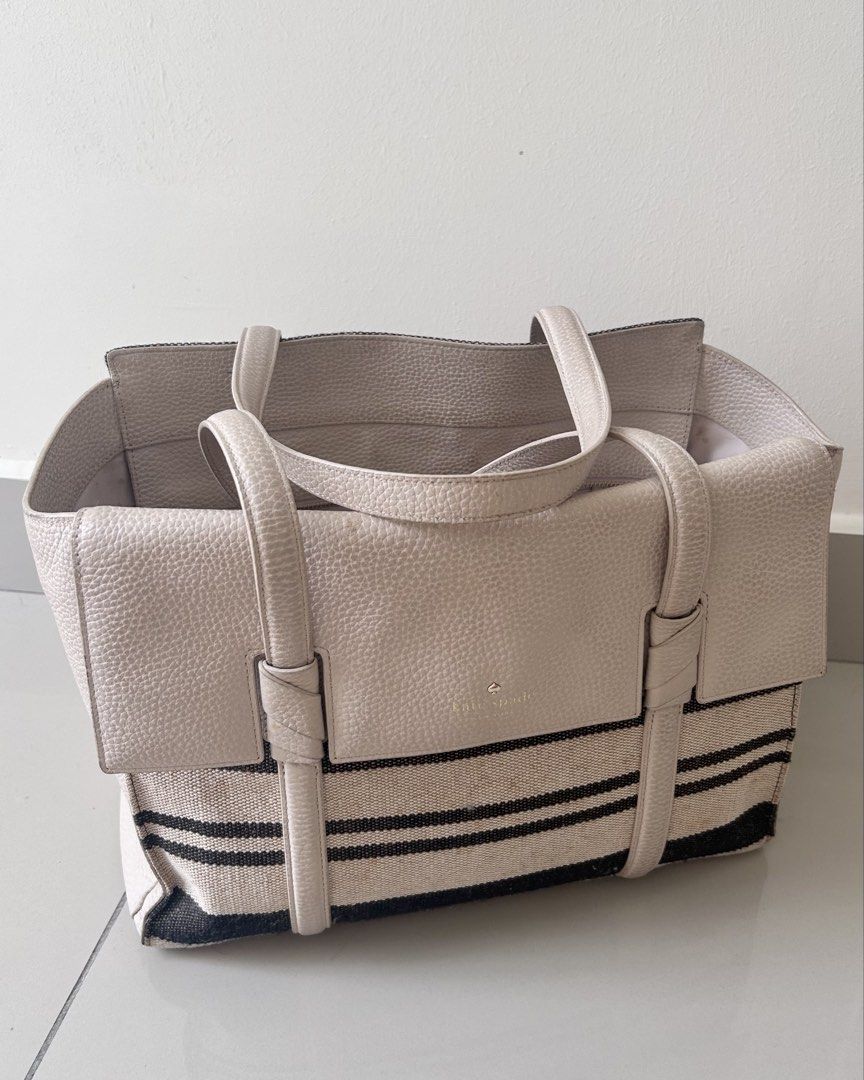 Authentic Kate Spade leather +canvas Tote Bag (Category: Tote Bags) located in Bangi. Submitted by fararara (Listing ID 1436824784, Image 1). Description: - Kate Spade tote bag - Beige leather exterior - Striped canvas detail - Two top handles - Spacious interior with multiple compartments and flapped closure - Includes a zipper at large compartment - bought at london for rm 1+++, letting go cheap for rm220 - only serious buyer to dm ❌❌NO NEGO NO