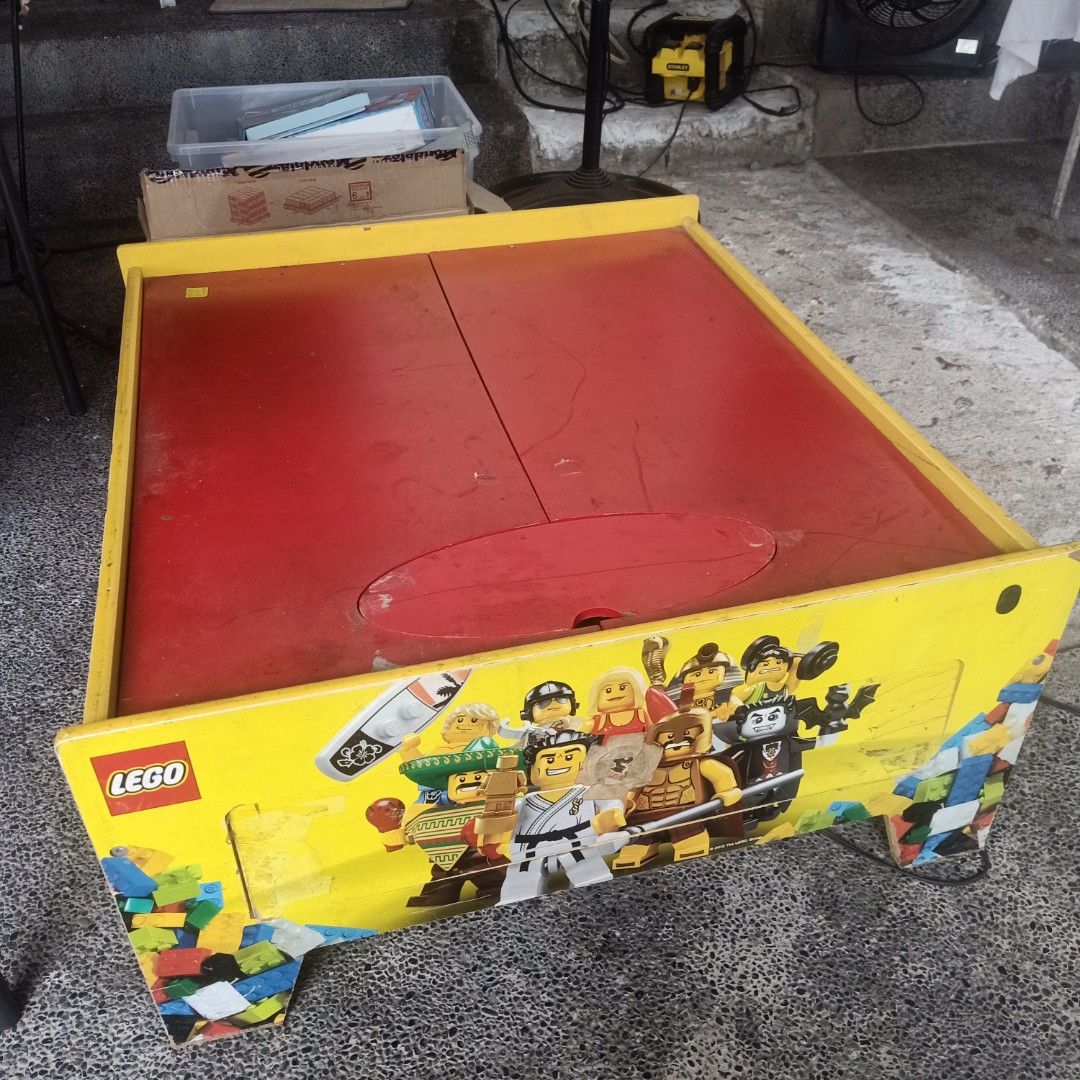 LEGO Play Table with Playmat (Category: Infant Playtime) located in Makati City. Submitted by pardsroman (Listing ID 1436667754, Image 3). Description: - LEGO play table with built-in road playmat - Features a yellow table with LEGO character graphics - Includes a red surface underneath the playmat - Comes with a power outlet - Ideal for kids and their LEGO bricks.