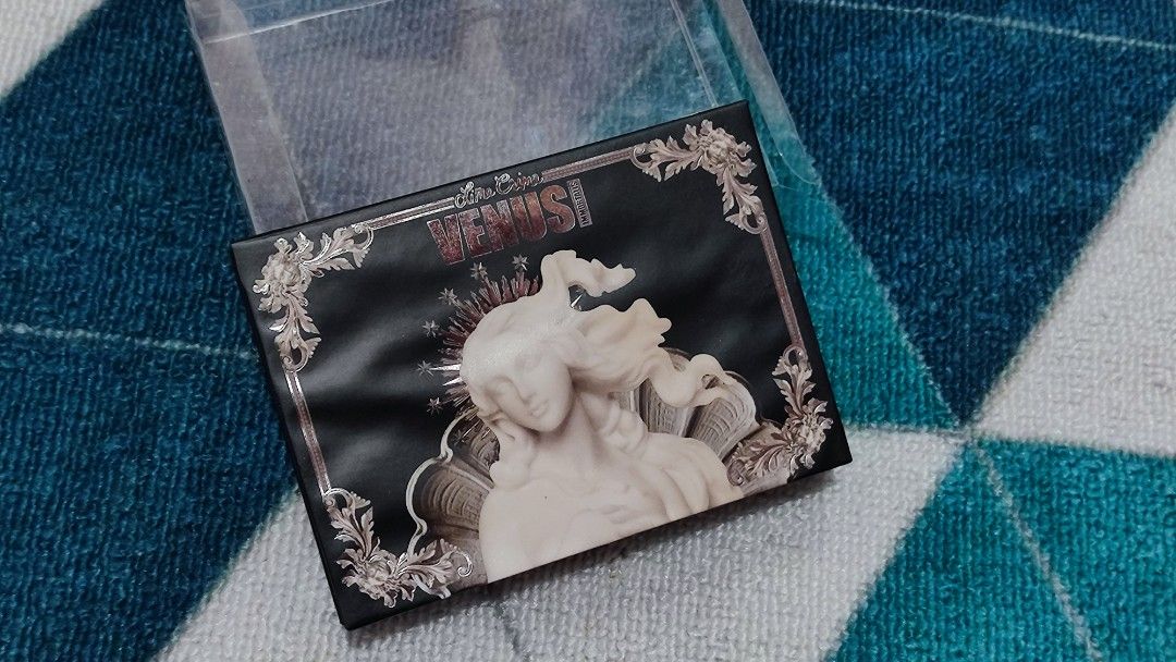 Lime Crime Venus Eyeshadow Palette (Category: Makeup) located in San Jose del Monte. Submitted by mimibelsss (Listing ID 1436682874, Image 2). Description: -Already discontinued (Lime Crime doesn't have a make up anymore) - UNUSED, never swatched - Cool-toned smoky shades - Built-in mirror - Glow-in-the-dark gilded box - Shades: Unseen, Moth, Marble, Unveil, Ash, Cameo -front display is a bit deformed, idk what happened? probably with storage bec