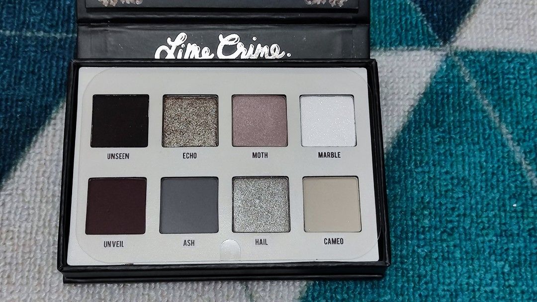 Lime Crime Venus Eyeshadow Palette (Category: Makeup) located in San Jose del Monte. Submitted by mimibelsss (Listing ID 1436682874, Image 3). Description: -Already discontinued (Lime Crime doesn't have a make up anymore) - UNUSED, never swatched - Cool-toned smoky shades - Built-in mirror - Glow-in-the-dark gilded box - Shades: Unseen, Moth, Marble, Unveil, Ash, Cameo -front display is a bit deformed, idk what happened? probably with storage bec