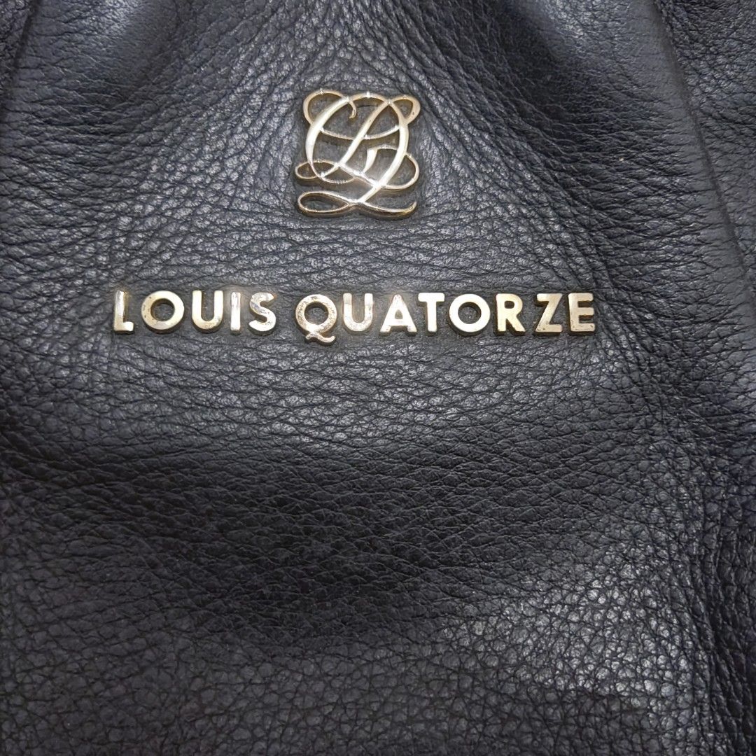 Louis Quatorze Black Handbag (Category: Luxury Bags & Wallets) located in Manila. Submitted by kyabhe (Listing ID 1436806806, Image 2). Description: - Louis Quatorze black handbag - Top handle and chain strap - Interior with patterned lining - Includes a zippered pocket - Brand name visible on exterior and interior - Metal logo on the front.