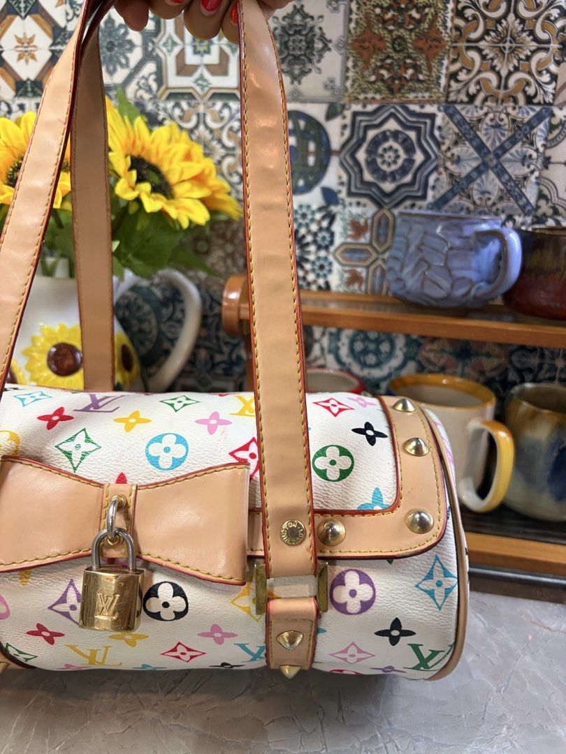 Louis Vuitton Multicolor Cylinder Bag (Category: Luxury Bags & Wallets) located in Pasig City. Submitted by bettinab27 (Listing ID 1436708710, Image 2). Description: - NGA Louis Vuitton Cylinder Bag - Multicolor design - Top handle and bow detail - Secure lock closure - Iconic LV monogram pattern - Light tan interior - Gold-tone hardware - Studded accents - Zipper closure.