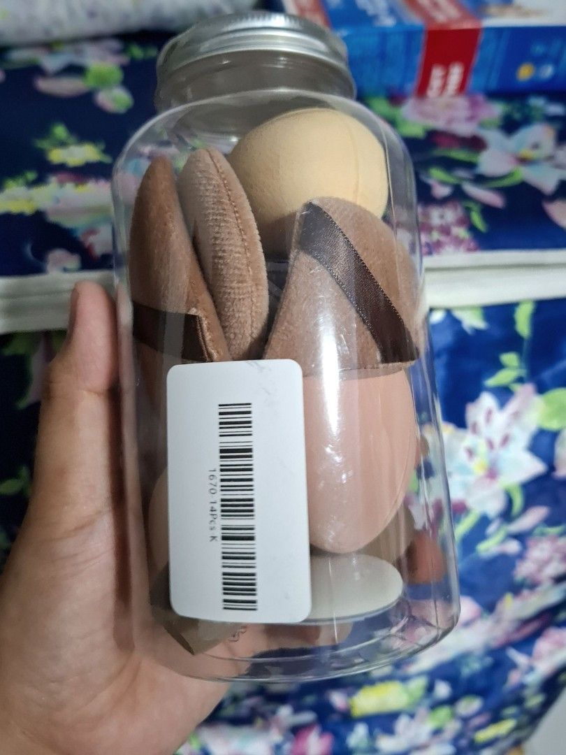 Makeup Sponge and Puff Set in Jar (Category: Makeup) located in Quezon City. Submitted by ana-chan (Listing ID 1436672107, Image 3). Description: - Makeup sponge and puff set - Comes in a clear jar for storage - Includes: - Teardrop sponges - Flat oval sponges - Triangular puffs - Colors: Beige, Brown, Pink - Perfect for applying foundation, concealer, and powder.
