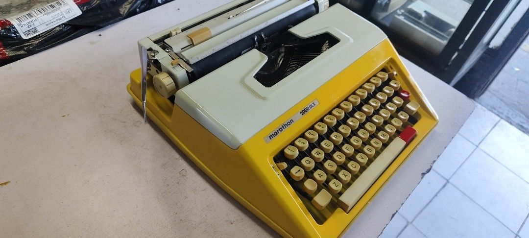 Marathon 2000dlx Typewriter manual (Category: Office & Business Technology) located in Manila. Submitted by tagaberick37031 (Listing ID 1436766834, Image 3). Description: Vintage Marathon 3000 SLX typewriter in a retro yellow and white design. Features a full keyboard, carriage return lever, and paper guide. Keys appear intact..