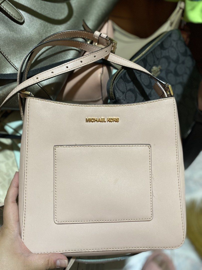 Michael Kors Messenger Crossbody Bag (Category: Luxury Bags & Wallets) located in Manila. Submitted by sophysells (Listing ID 1436754715, Image 1). Description: ONLY USED TWICE. Still in perfect condition! - Michael Kors shoulder bag - Light pink color - Rectangular front pocket - Gold-toned Michael Kors logo - Zipper closure - Adjustable shoulder strap - Interior zippered pocket - Michael Kors label Meet-up: SM Baguio Delivery: J&T or LBC (Buyer