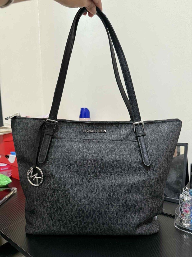 Michael Kors Tote Bag (Category: Luxury Bags & Wallets) located in Cagayan de Oro. Submitted by iammaica (Listing ID 1436815127, Image 1). Description: - Michael Kors tote bag - Classic black and gray monogram pattern - Double shoulder straps - Top zipper closure - Front pocket - Silver MK logo charm - Perfect for everyday use - Stylish and functional.