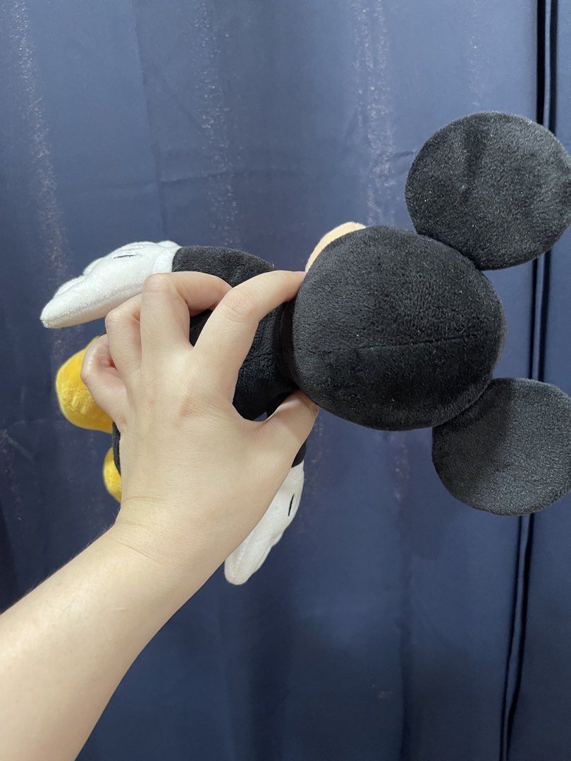 Mickey Mouse Plush Toy (Category: Toys & Games) located in Taguig. Submitted by supplementary (Listing ID 1436672604, Image 2). Description: - Classic Mickey Mouse plush toy - Features iconic Mickey Mouse design - Black ears and body - Red shorts - Yellow shoes - White gloves - Soft and cuddly material - Great for Disney fans of all ages - Perfect gift or collectible.