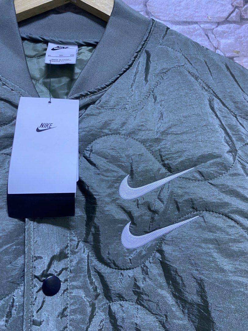 Nike Swoosh Quilted Jacket embroidered logo (Category: Coats, Jackets and Outerwear) located in Manila. Submitted by ownywest833 (Listing ID 1436777924, Image 3). Description: 9500 pesos only✅ from 15,095 SRP ❌ size XL brandnew authentic with hangtags and plastic.
