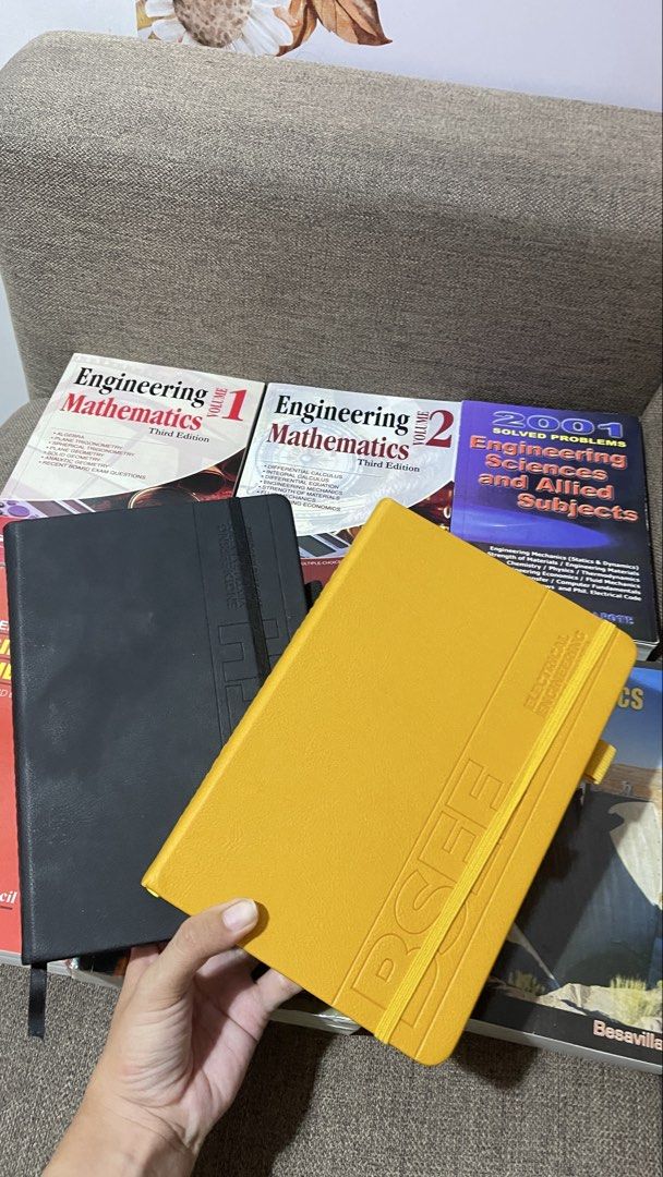 Notebooks and Engineering Books (Category: Textbooks) located in Mandaue City. Submitted by delacruzsh40119 (Listing ID 1436769431, Image 1). Description: - Engineering Books: - "Engineering Mathematics" Volume 1 - "Engineering Mathematics" Volume 2 - "Solved Problems in Engineering Sciences and Allied Subjects" - Notebooks: - One black notebook - One yellow notebook with "BSEE ELECTRICAL ENGINEERING" printed on it.