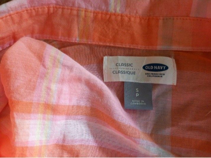 Old Navy Classic Plaid Shirt - Small (Category: Coats, Jackets and Outerwear) located in Lamut. Submitted by sakosack (Listing ID 1436783740, Image 2). Description: - Old Navy Classic Shirt - Size: Small - Color: Orange and pink plaid - Features: Long sleeves, button-down front, classic collar, single chest pocket - Fabric: Lightweight, suitable for warm weather - Made in Cambodia.