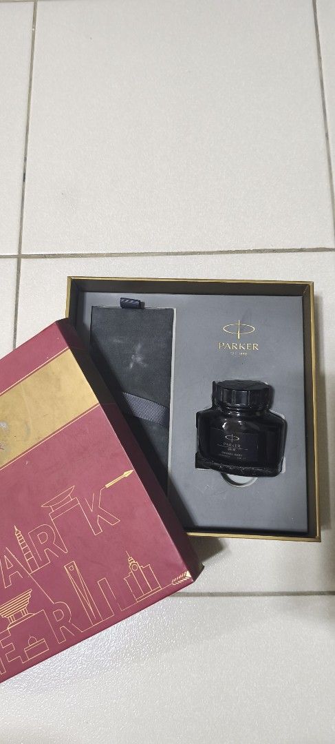Parker Quink Ink Bottle (Category: Stationery & School Supplies) located in Manila. Submitted by boldstone-3703 (Listing ID 1436789582, Image 2). Description: - Parker Quink black ink bottle - Presented in a gift box - Includes a compartment for a pen - Features the Parker logo - Bottle labeled "Quink".