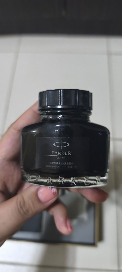 Parker Quink Ink Bottle (Category: Stationery & School Supplies) located in Manila. Submitted by boldstone-3703 (Listing ID 1436789582, Image 3). Description: - Parker Quink black ink bottle - Presented in a gift box - Includes a compartment for a pen - Features the Parker logo - Bottle labeled "Quink".