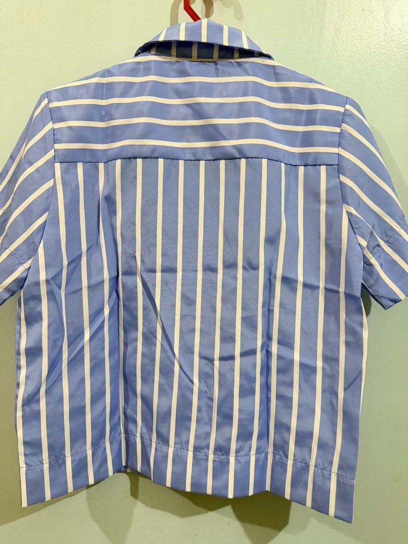 Plains & Prints Striped Top (Category: Blouses) located in Quezon City. Submitted by bela_goodfinds (Listing ID 1436737402, Image 3). Description: - Blue and white striped pattern - Short sleeves - Collared neckline - Decorative fabric detail on the front - Size: PH XS, UK6, US2 - Button-down closure.