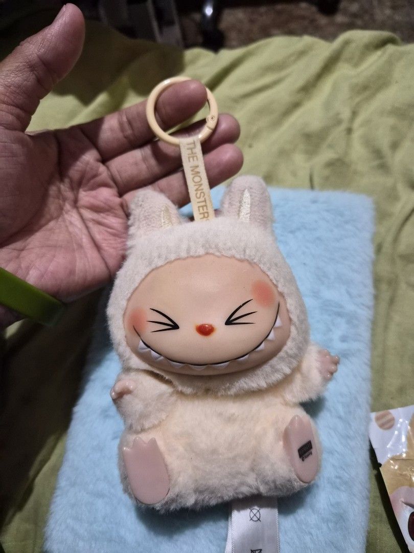 Pop Mart Labubu Have a Seat Keychain (Category: Designer & Blind Box Toys) located in Mandaue City. Submitted by chuchi152615 (Listing ID 1436751754, Image 1). Description: - Adorable Labubu keychain from Pop Mart. - Features a cute sheep design with a smiling face. - Comes with original box and packaging. - Perfect for adding a touch of fun to your bag or keys. - Made of soft, plush material..