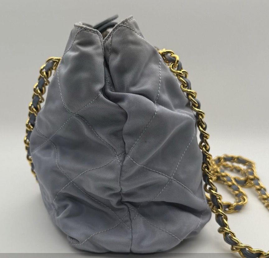 Prada Quilted Chain Shoulder Bag (Rare Color) (Category: Luxury Bags & Wallets) located in Quezon City. Submitted by shopandlearn (Listing ID 1436755732, Image 3). Description: - Authentic Prada handbag - Quilted design - Stylish chain strap (gold & grey leather) - Light blue-grey color - Gold-tone hardware (super clean) - Drawstring closure - Features the iconic Prada triangular logo.