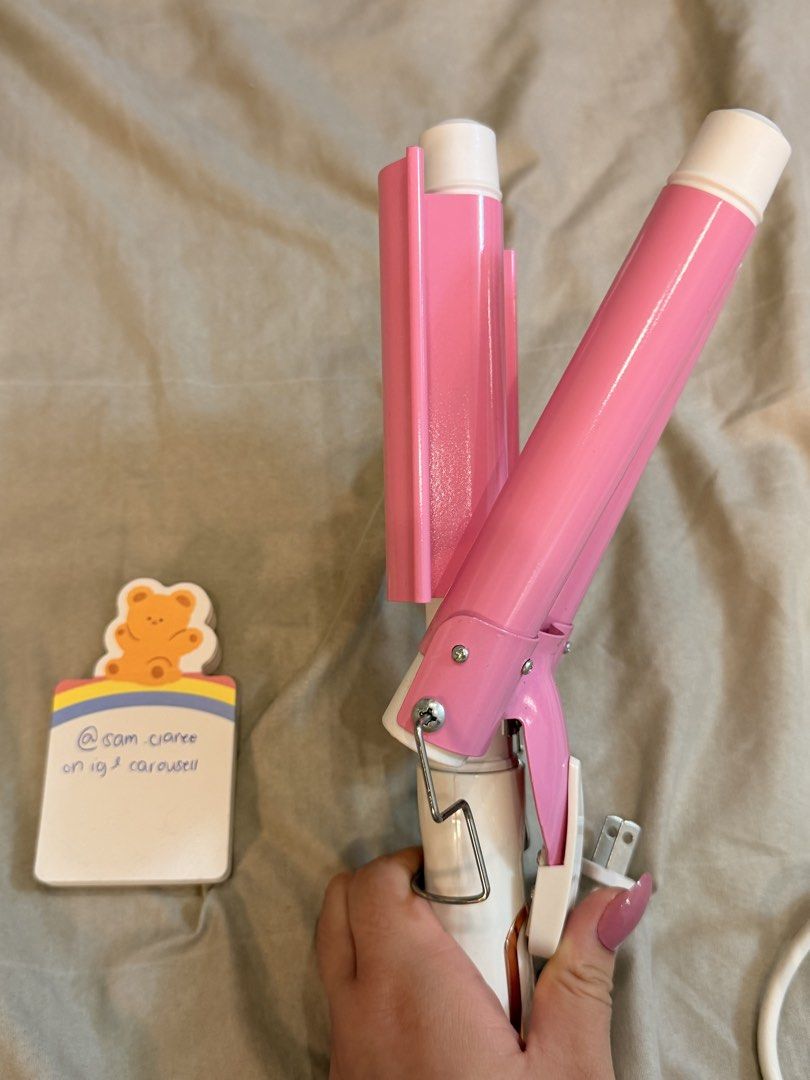 PRELOVED UBEATOR Pink Hair Waver (Category: Hair) located in Manila. Submitted by sam.claree (Listing ID 1436780363, Image 2). Description: PRELOVED Ubeator triple barrel ceramic hair waver in pink and white. - bought from orange app, and Creates beautiful, beachy waves - has three barrels for easy styling (pink and white design) - White cord and standard plug rfs: can no longer use on my hair (i bleached it huhu).
