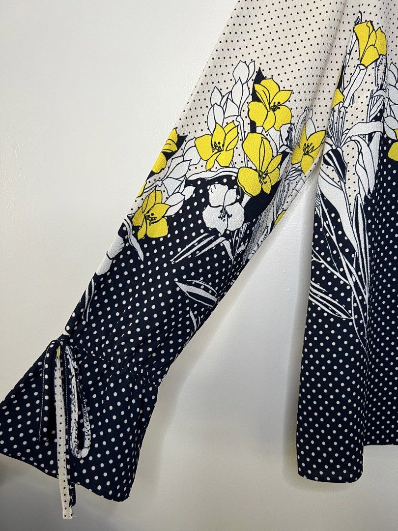 Principles Floral Polka Dot Long Sleeve Blouse (Category: Blouses) located in Quezon City. Submitted by pcera (Listing ID 1436777352, Image 3). Description: - Principles blouse - Size 12 - Navy blue polka dot pattern with floral accents - Long sleeves with tie details at cuffs - Round neckline with navy blue trim.