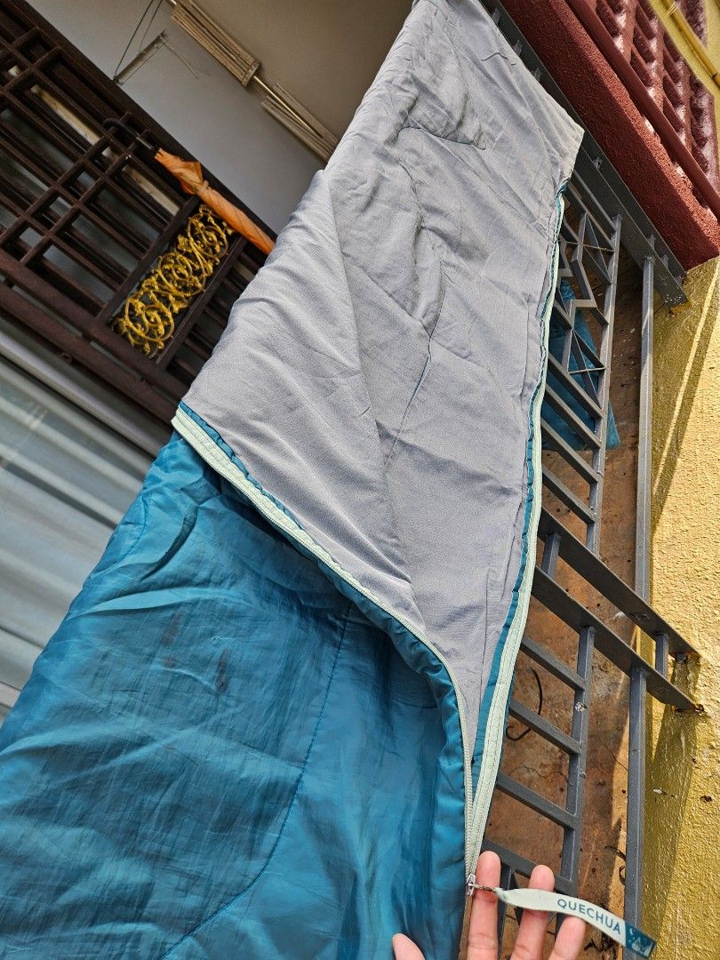 Quechua Basic Sleeping Bag (Category: Hiking & Camping) located in Bakri. Submitted by khaizat96 (Listing ID 1436711796, Image 2). Description: - Can try & see the material first before pay - Quechua Basic sleeping bag in teal. - Grey interior. - Designed for a person up to 20" x 68". - Comes with a carrying bag. - Ideal for camping or travel. 🚩 Have a small hole resulted from fire ashes (not compromising the usage, burn at outer layer only).
