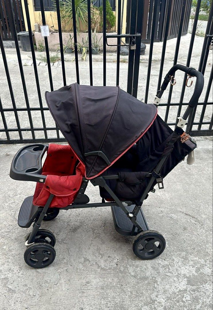 RUSH !! Double Stroller (Category: Strollers) located in Quezon City. Submitted by ivydqueen29 (Listing ID 1436714930, Image 1). Description: - Double stroller - Black canopy - Red seats - Snack and drink tray - Four wheels - Footrest - Black handle - Ready for use.