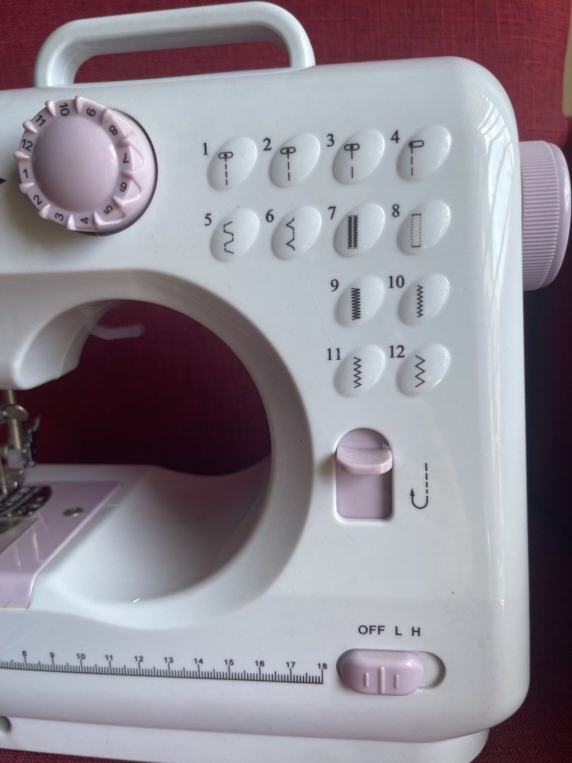 Sewing Machine (Category: Craft Supplies & Tools) located in Mandaluyong City. Submitted by manilasyoungstunna (Listing ID 1436705833, Image 2). Description: RFS: sewing phase ended A little dusty but still works! - Portable sewing machine - Multiple stitch patterns - Includes foot pedal for easy operation - Built-in drawer for accessories - Convenient handle for portability - Comes with power adapter and foot pedal - Stylish white and pink color