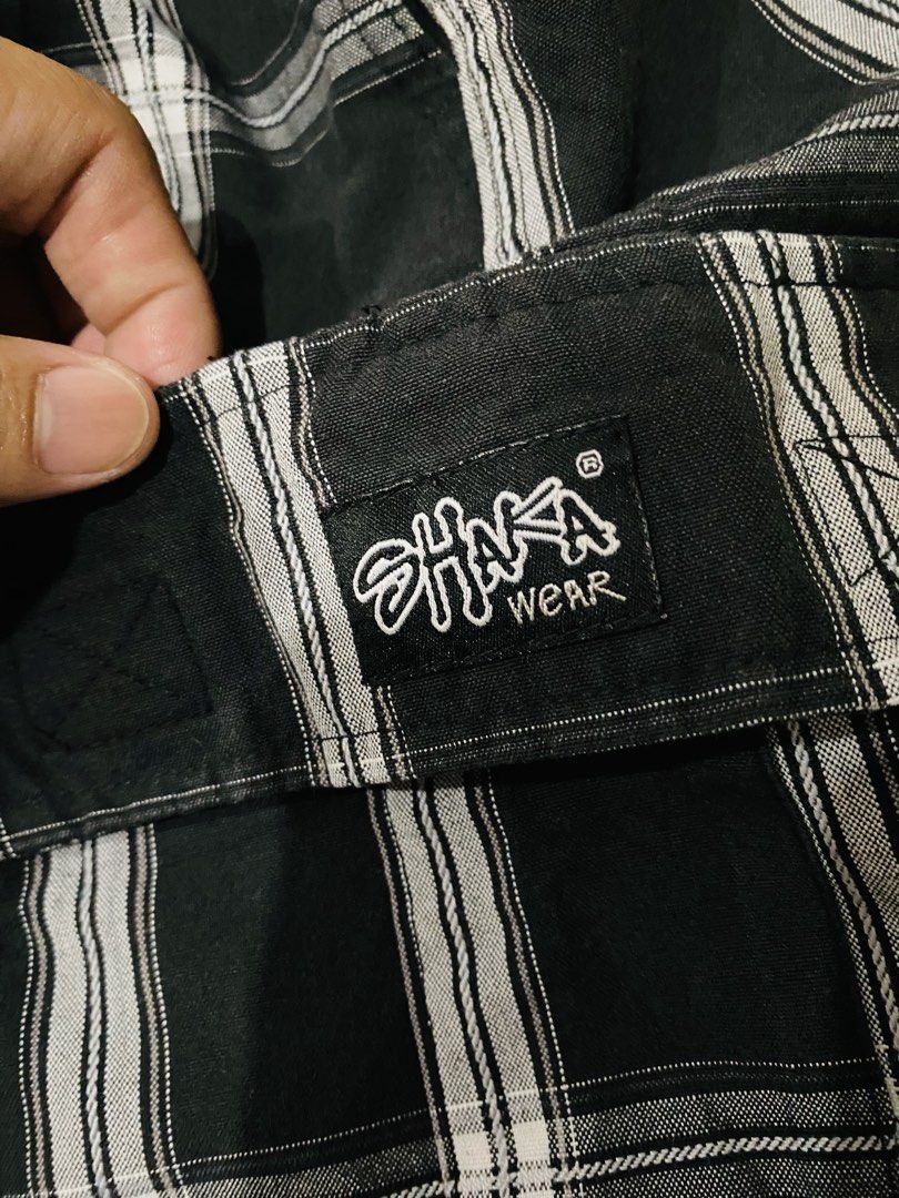 Shaka Wear Plaid Cargo Shorts (Category: Shorts) located in Manila. Submitted by alsytan (Listing ID 1436787764, Image 2). Description: - Shaka Wear cargo shorts - Black and white plaid pattern - Two cargo pockets - Elastic waistband - Length: Approximately 23 inches - Waist: Approximately 12 inches - Brand tag visible.