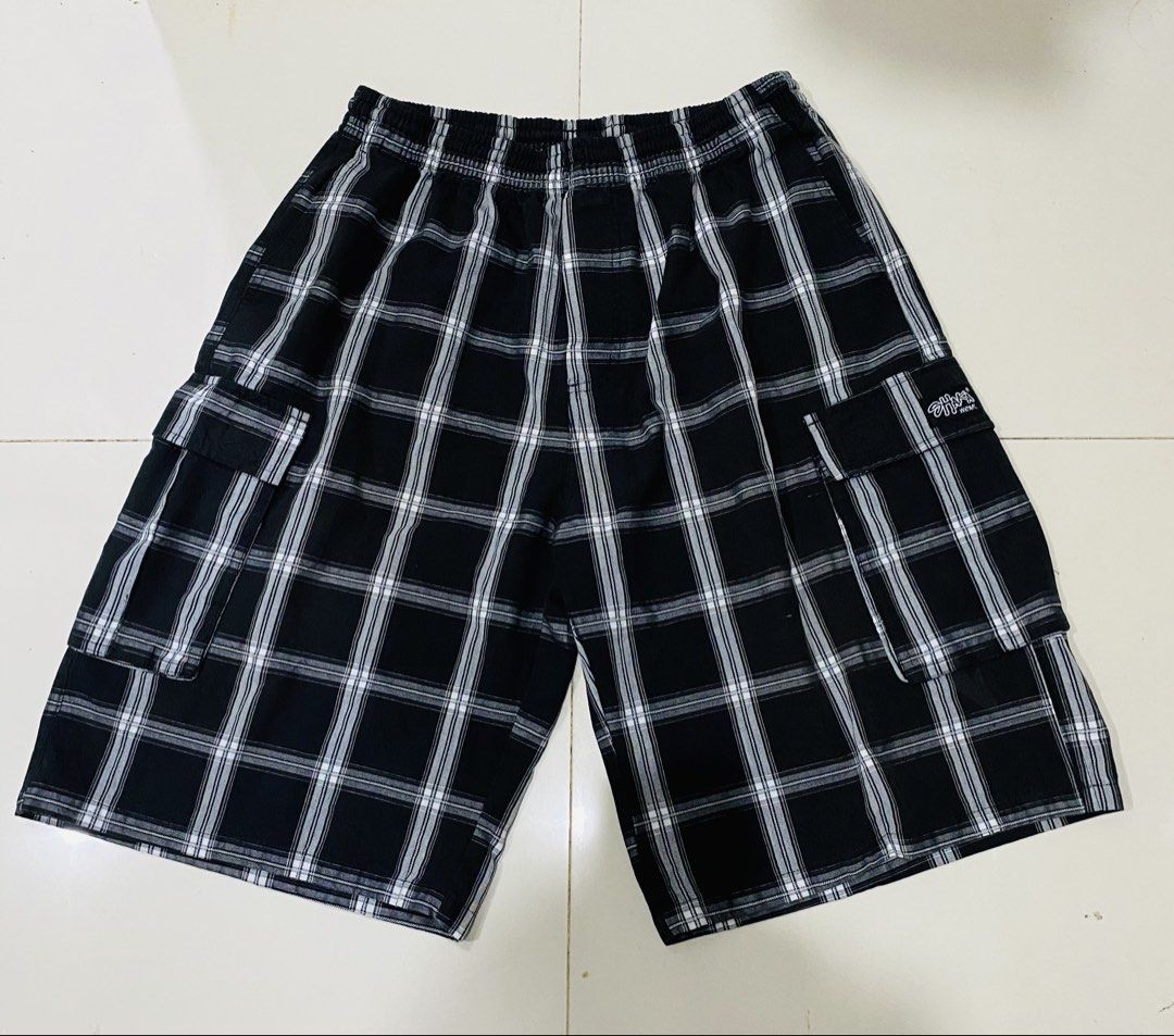 Shaka Wear Plaid Cargo Shorts (Category: Shorts) located in Manila. Submitted by alsytan (Listing ID 1436787764, Image 1). Description: - Shaka Wear cargo shorts - Black and white plaid pattern - Two cargo pockets - Elastic waistband - Length: Approximately 23 inches - Waist: Approximately 12 inches - Brand tag visible.