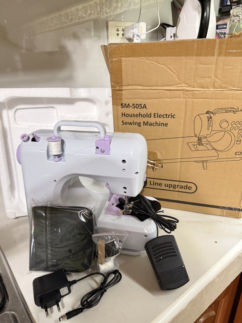 SM-505A Household Electric Sewing Machine (Category: Other Home Appliances) located in Manila. Submitted by jj11662 (Listing ID 1436713703, Image 2). Description: - SM-505A Electric Sewing Machine - 12 Stitch Patterns - Two-Lane Sewing - Two Speed Settings - Includes Foot Pedal - Built-in Small Light - Small Drawer for Accessories - Power Options: DC 6V or 4AA Batteries - Package Includes: Sewing Machine, Foot Pedal, Power Adapter, and Accessorie