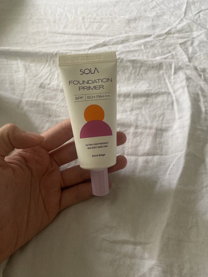SOLA Foundation Primer SPF 50+ PA+++ (Category: Makeup) located in Lila. Submitted by atfnya (Listing ID 1436793894, Image 1). Description: - SOLA Foundation Primer - Shade: Sand Beige - SPF 50+ PA+++ - Ultra-lightweight - New, sealed tube - White tube with purple cap - Brand name and product details printed on packaging.
