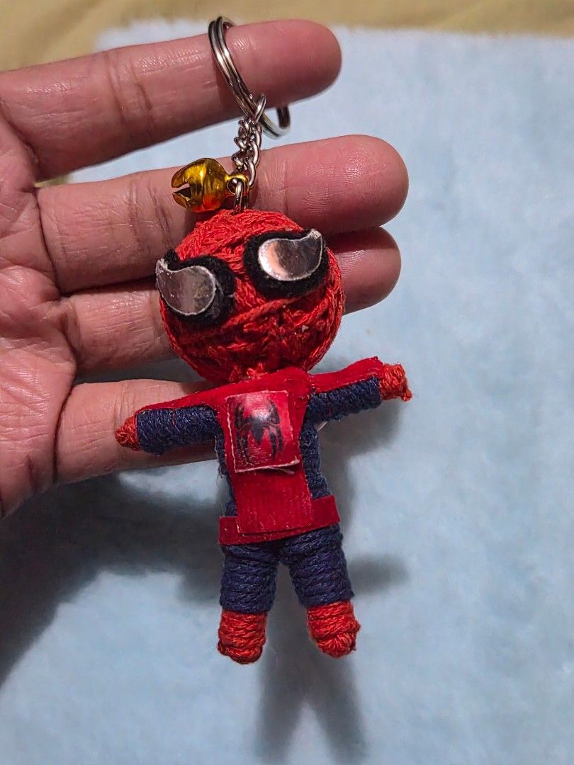 Spider-Man Keychain with Bell (Category: Character Goods) located in Mandaue City. Submitted by chuchi152615 (Listing ID 1436719537, Image 3). Description: - Handmade Spider-Man keychain - Features a red and blue Spider-Man figure - Includes a bell attachment - Made of durable yarn - Comes with a sturdy metal ring - Detailed Spider-Man design - Perfect for Marvel enthusiasts!.