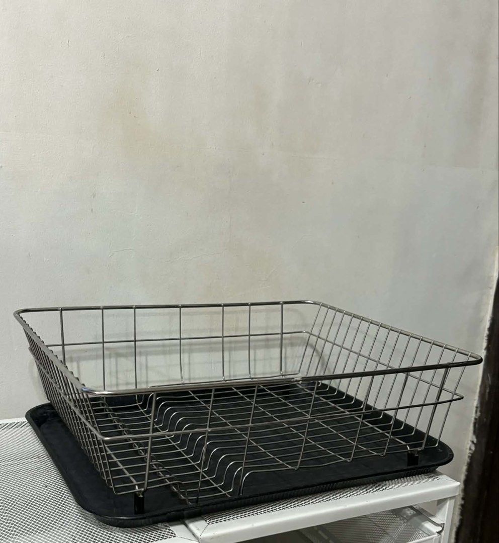 Stainless Steel Dish Rack with Tray (Category: Other Kitchenware & Tableware) located in Quezon City. Submitted by tess1976 (Listing ID 1436715740, Image 3). Description: - Stainless steel dish rack - Includes a black tray - Rectangular shape - Wire frame design - Slots for plates and utensils.