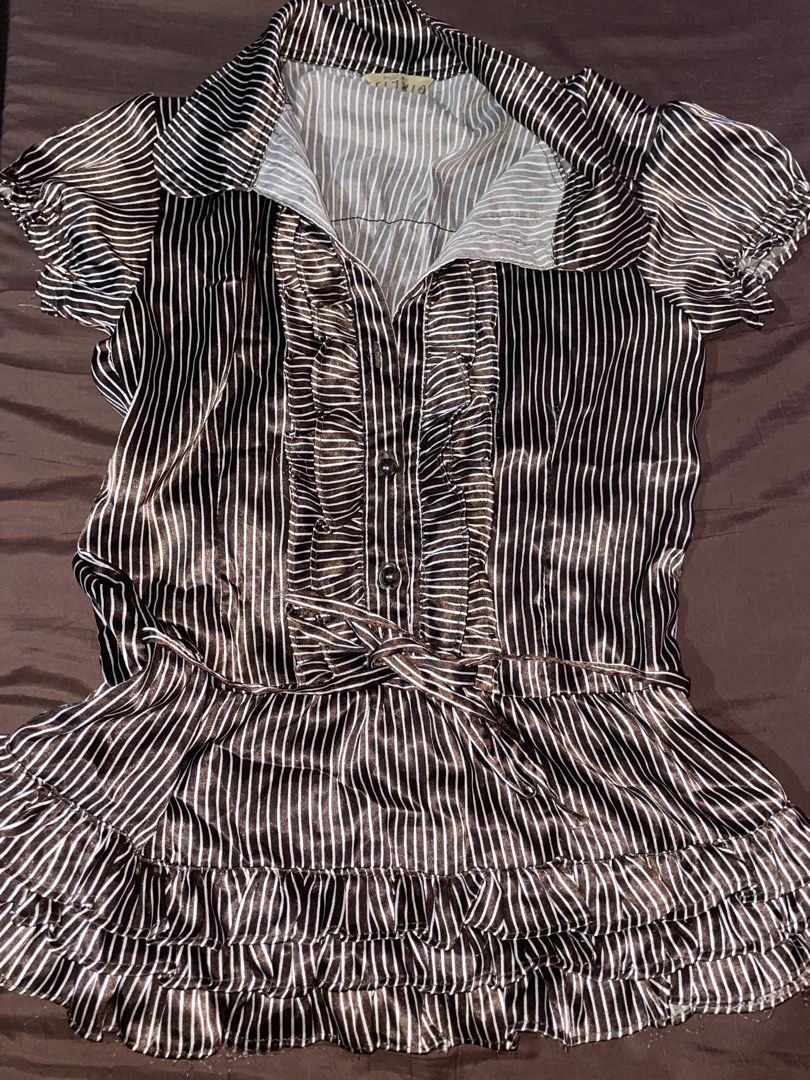 Striped Ruffled Blouse (Category: Blouses) located in Quezon City. Submitted by radiusmile (Listing ID 1436808218, Image 1). Description: - Striped pattern - Collared neckline - Short sleeves - Button-down front - Ruffled detailing - Waist tie - Ruffled hem - Fabric with a slight sheen.