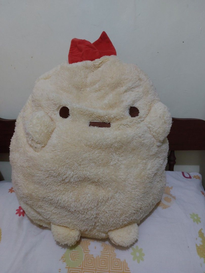 Sumikko Gurashi Chicken Plush Pillow (Category: Plushies & Soft Toys) located in Mandaluyong City. Submitted by 13thsilverrabbit (Listing ID 1436809946, Image 1). Description: Adorable Sumikko Gurashi plush pillow features a chicken design. It has a soft, fluffy texture and a red bow. The plush is in a round shape. The tag indicates it is a 2020 San-X product. Perfect for cuddling or as a decorative piece..