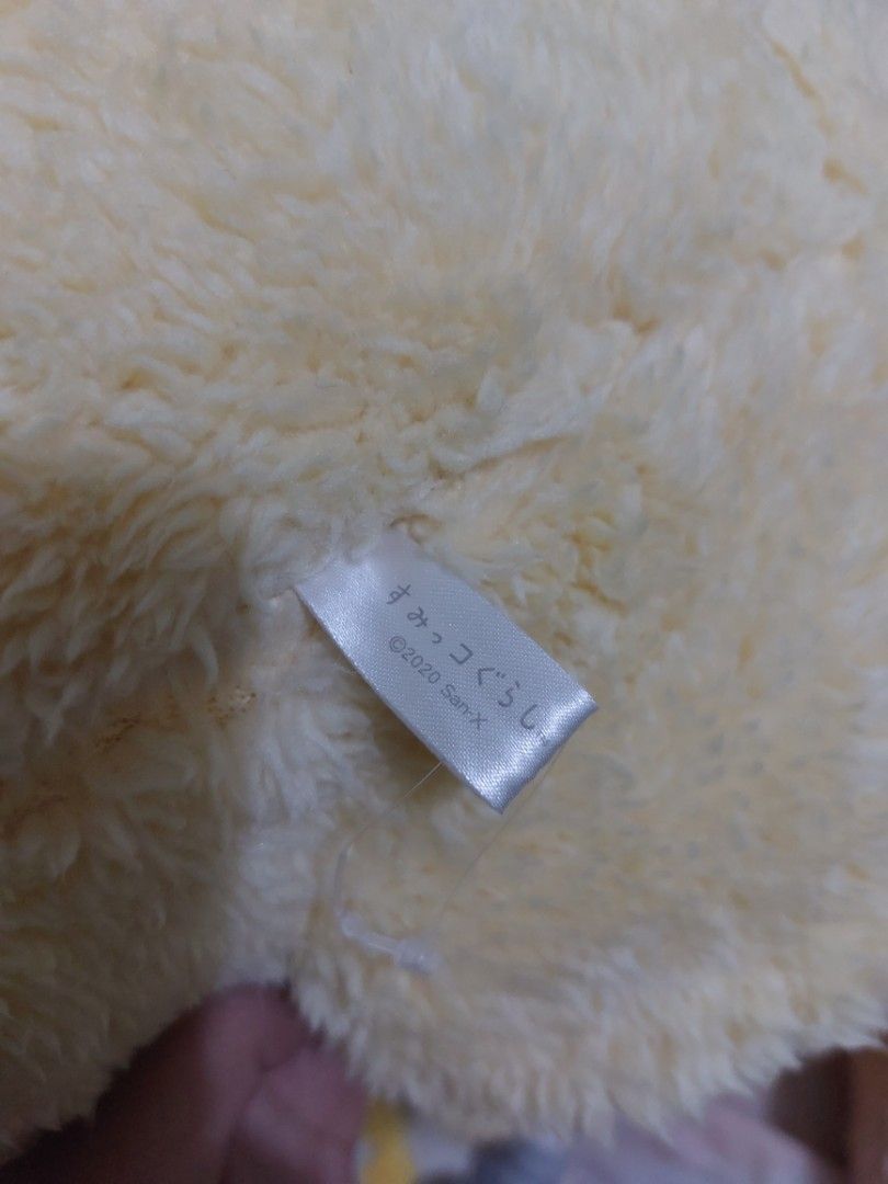 Sumikko Gurashi Chicken Plush Pillow (Category: Plushies & Soft Toys) located in Mandaluyong City. Submitted by 13thsilverrabbit (Listing ID 1436809946, Image 2). Description: Adorable Sumikko Gurashi plush pillow features a chicken design. It has a soft, fluffy texture and a red bow. The plush is in a round shape. The tag indicates it is a 2020 San-X product. Perfect for cuddling or as a decorative piece..