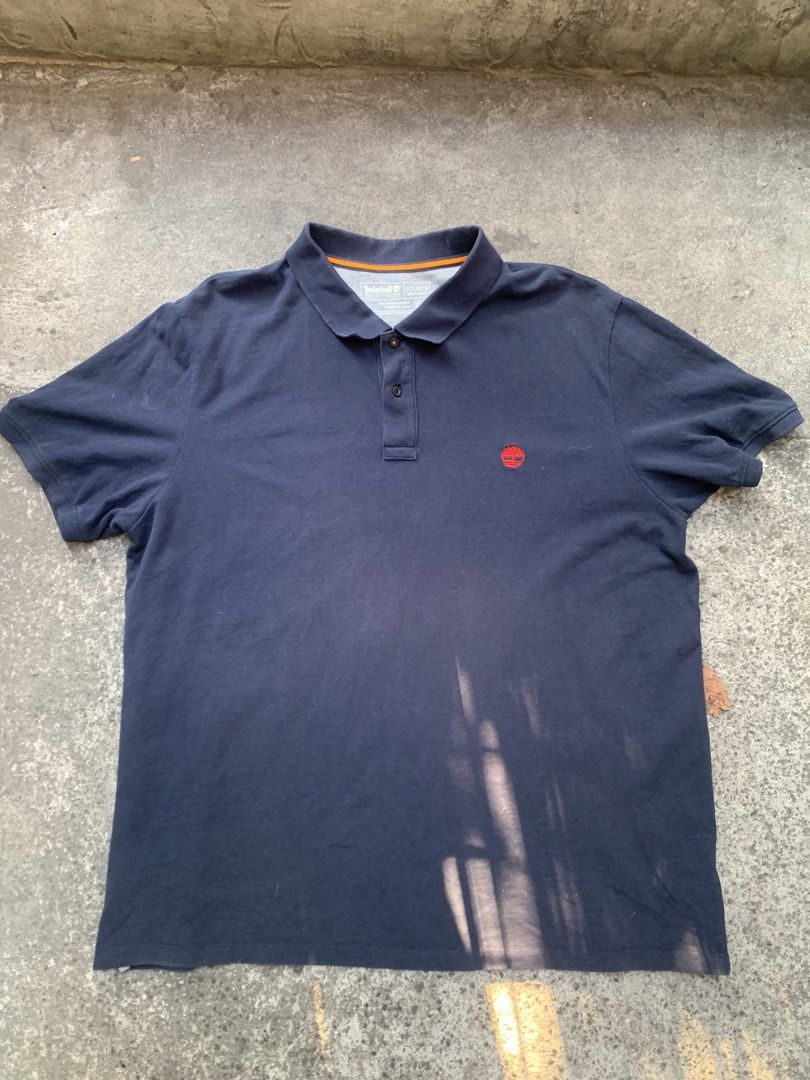 Timberland Polo Shirt XL (Category: Tshirts & Polo Shirts ) located in Manila. Submitted by dendenocil51476 (Listing ID 1436734609, Image 3). Description: - Navy blue Timberland polo shirt - Size: 3XL - Material: Cotton - Features Timberland logo - Collared neckline with three-button placket.
