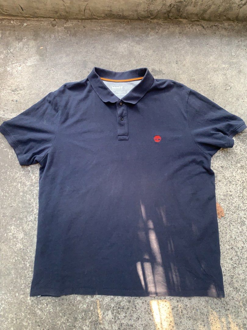 Timberland Polo Shirt XL (Category: Tshirts & Polo Shirts ) located in Manila. Submitted by dendenocil51476 (Listing ID 1436734609, Image 1). Description: - Navy blue Timberland polo shirt - Size: 3XL - Material: Cotton - Features Timberland logo - Collared neckline with three-button placket.