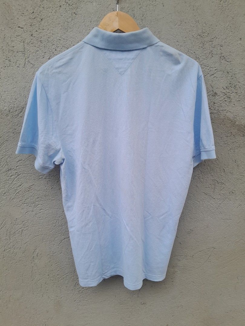 Tommy Hilfiger Light Blue Polo Shirt (Category: Tshirts & Polo Shirts ) located in Manila. Submitted by phil_thrift (Listing ID 1436655414, Image 2). Description: - Tommy Hilfiger Light blue polo shirt - Classic collar and short sleeves - Features a small logo on the chest - Three-button placket - Lightweight fabric, ideal for warm weather.
