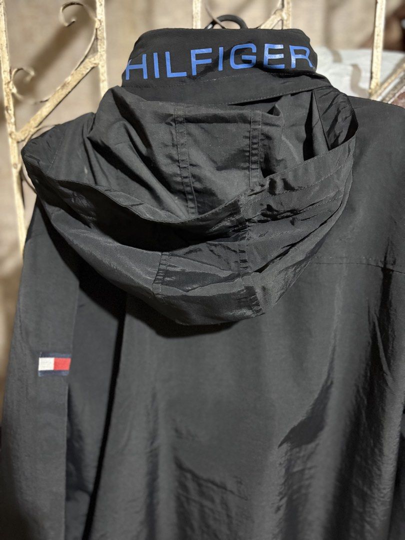 Tommy Hilfiger Men's Lightweight Waterproof Regatta Jacket (Category: Coats, Jackets and Outerwear) located in Manila. Submitted by jazerbisma54088 (Listing ID 1436690813, Image 3). Description: - Tommy Hilfiger men's regatta jacket - Lightweight and waterproof - Color: Black with blue accents - Features a hood - Zipper closure - Tommy Hilfiger logo on chest and hood - Size: XL 21x30 - Waterstop feature .