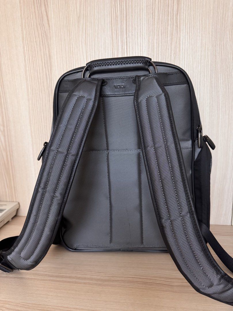 Tumi Larson Medium Backpack (Category: Backpacks) located in Quezon City. Submitted by katharus (Listing ID 1436693308, Image 2). Description: Exterior Features: - Carbon fiber detailing on right panel - Zip entry to main compartment with magnetic zip garage - Back zip entry to quilted laptop compartment (fits up to a 15” PC or 16” MacBook screen) with magentic zip garage - Padded mesh back panel for comfort and support - Add-a-Bag sleeve - Hidde