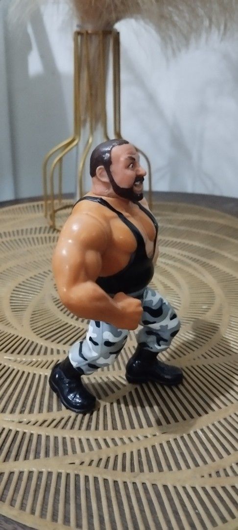 1991 Hasbro WWF Bushwacker Luke action figure (Category: Action & Battle Toys) located in Manila. Submitted by ventajetoyz625 (Listing ID 1436678889, Image 2). Description: - Vintage wrestling action figure - Muscular wrestler design - Black tank top and camouflage pants - Detailed with a beard - Flexing arm pose - Made of plastic - "Gimmick" not working - What you see is what you get.